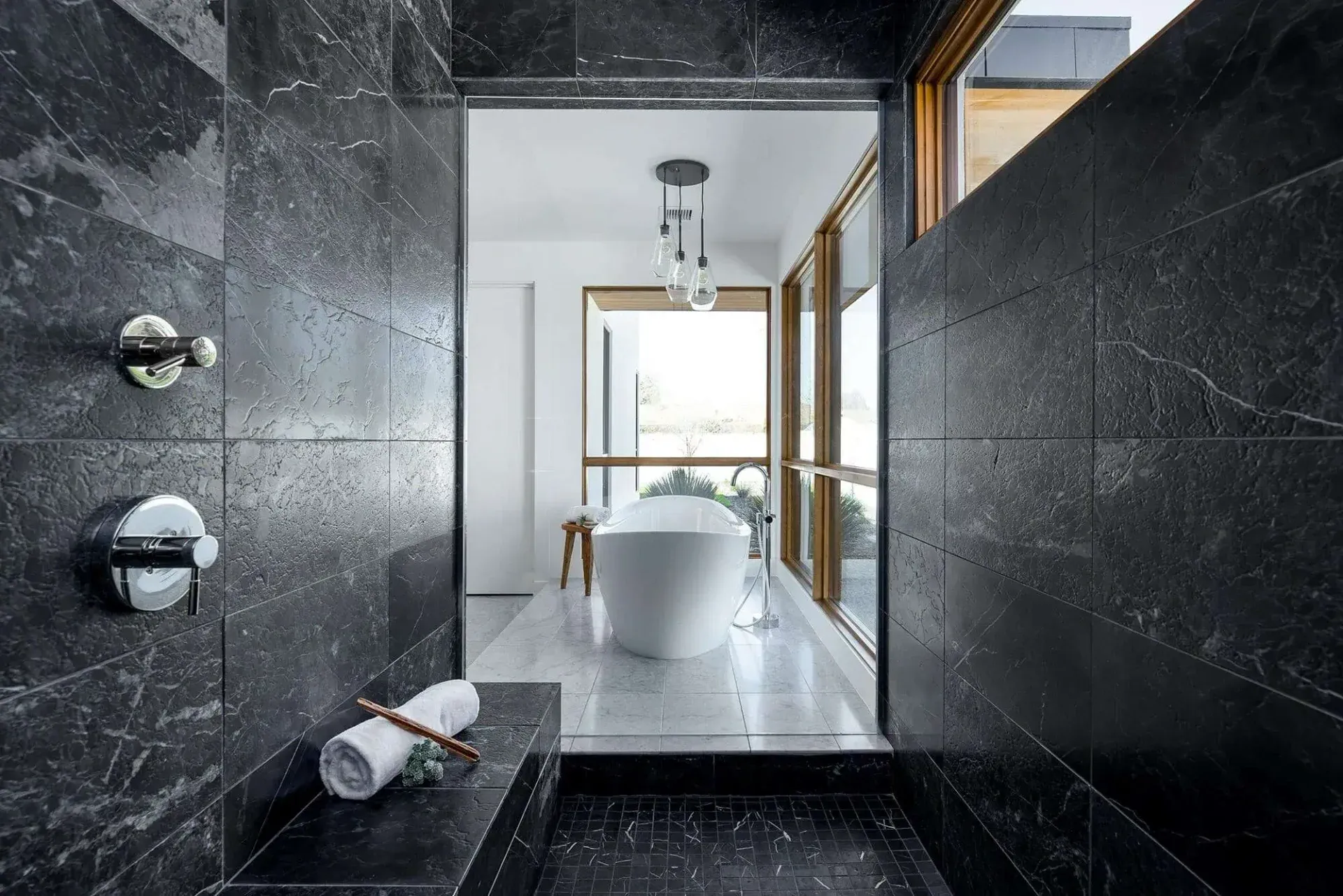 Spacious shower with built-in bench and centerpiece tub